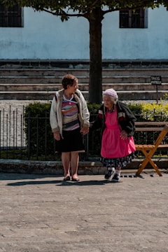 man in gray blazer standing beside woman in red coat