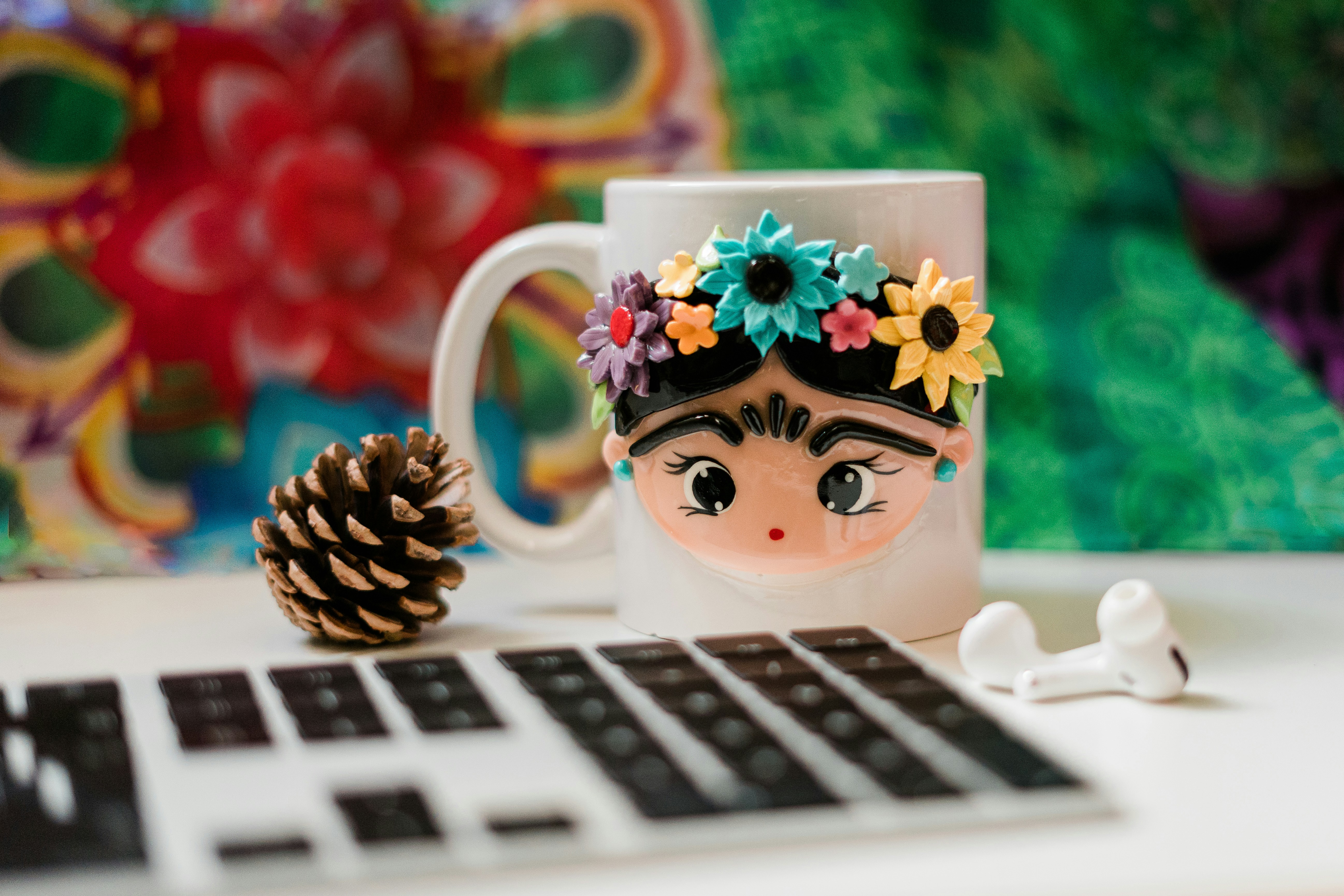 white and black cat ceramic mug on macbook pro, Coffee break at my desk with a colourful Frida Kahlo mug