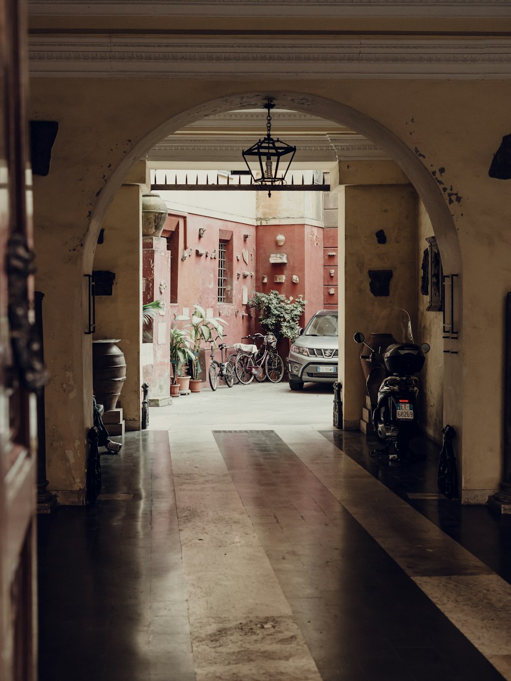 man in white shirt walking on hallway