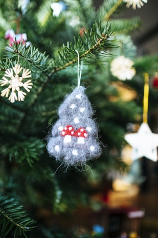 Handmade ornaments hanging on a Christmas tree.