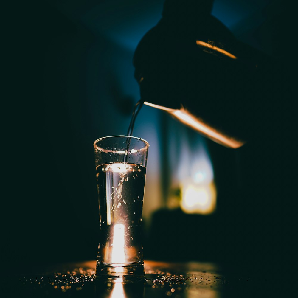 water pouring on clear drinking glass