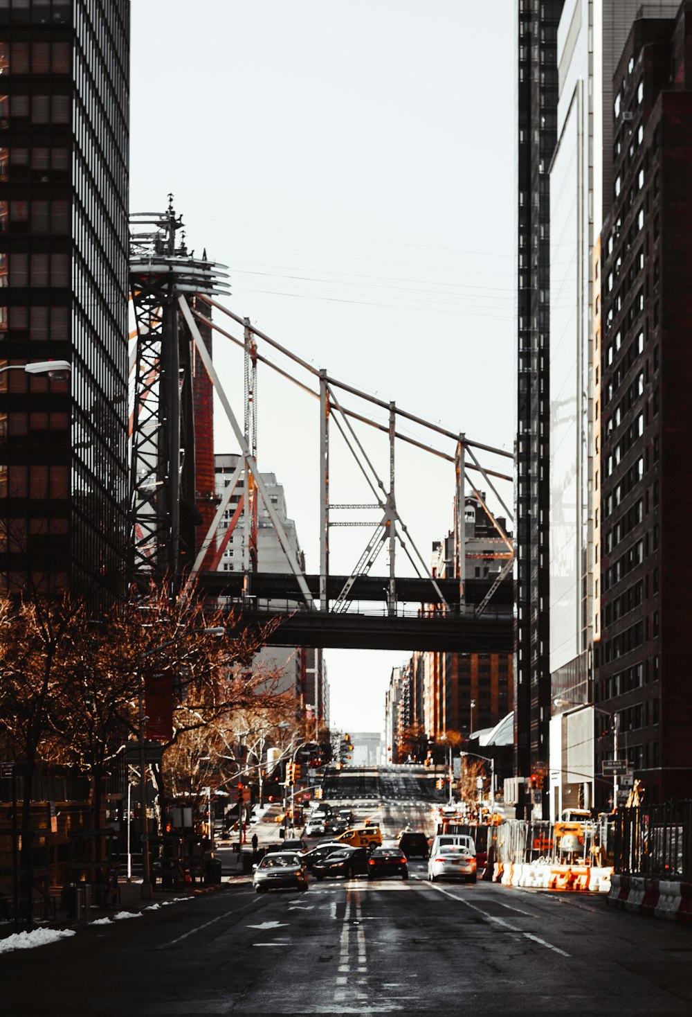 cars on road near bridge during daytime