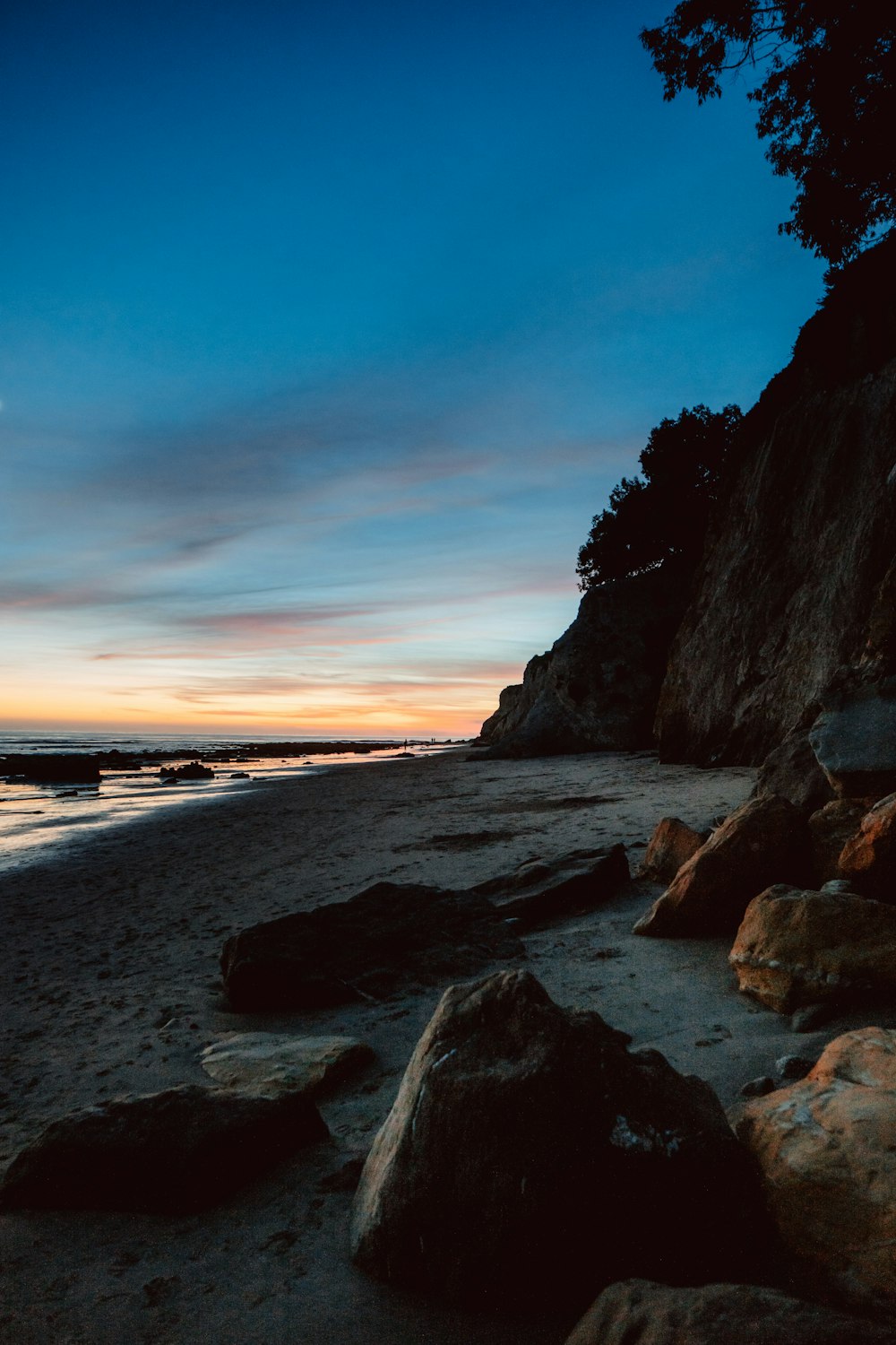 brown rocky shore during sunset