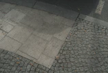 A decorative concrete sidewalk featuring stamped patterns and clean lines in a residential neighborhood.