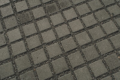 A close-up of paver slabs and a well-maintained irrigation system.