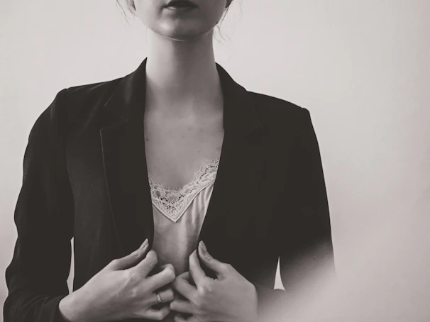 A high-resolution photo of a model wearing a sharply tailored suit with subtle textures under soft natural lighting