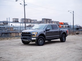 black chevrolet crew cab pickup truck on road during daytime