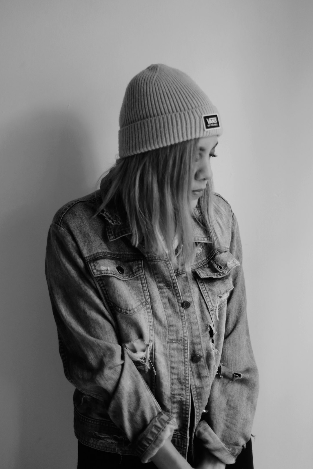 woman in black knit cap and denim jacket