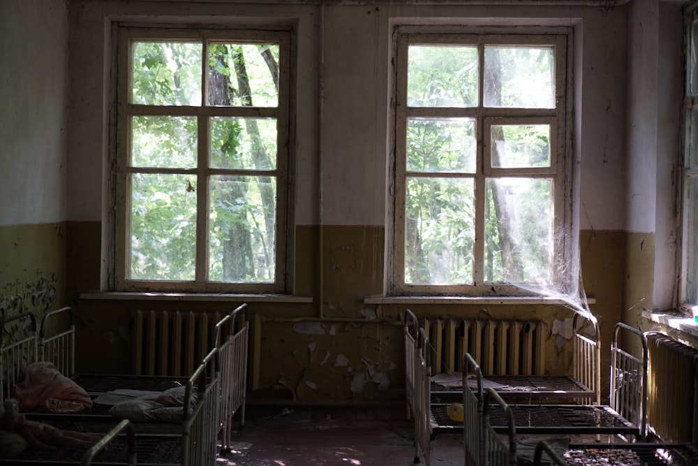 brown wooden chairs and table near window