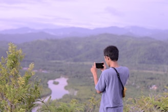 A traveler using a smartphone in a scenic location.