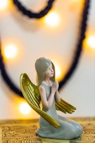 woman in green dress figurine