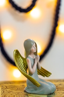 woman in green dress figurine