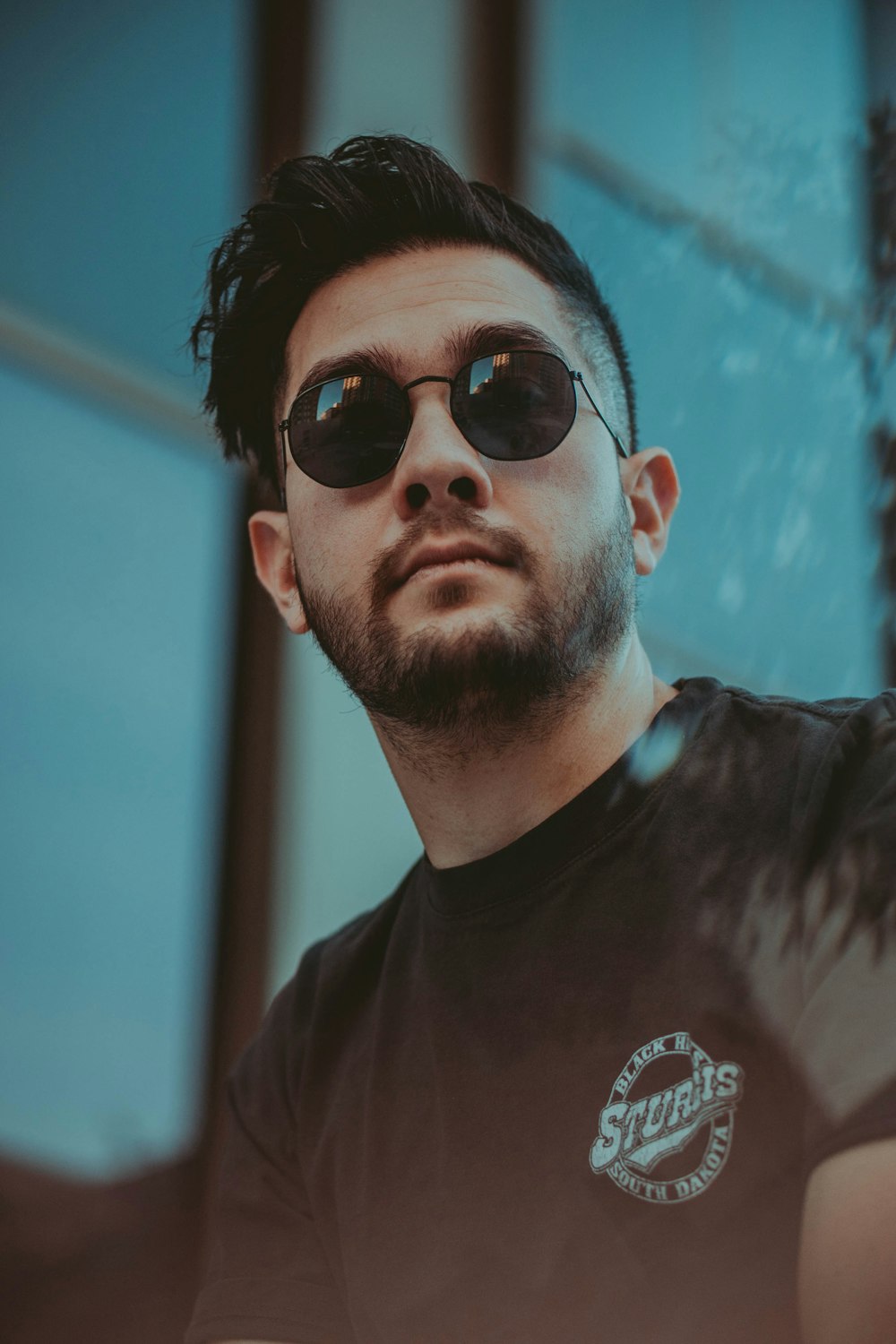 man in black crew neck shirt wearing black sunglasses