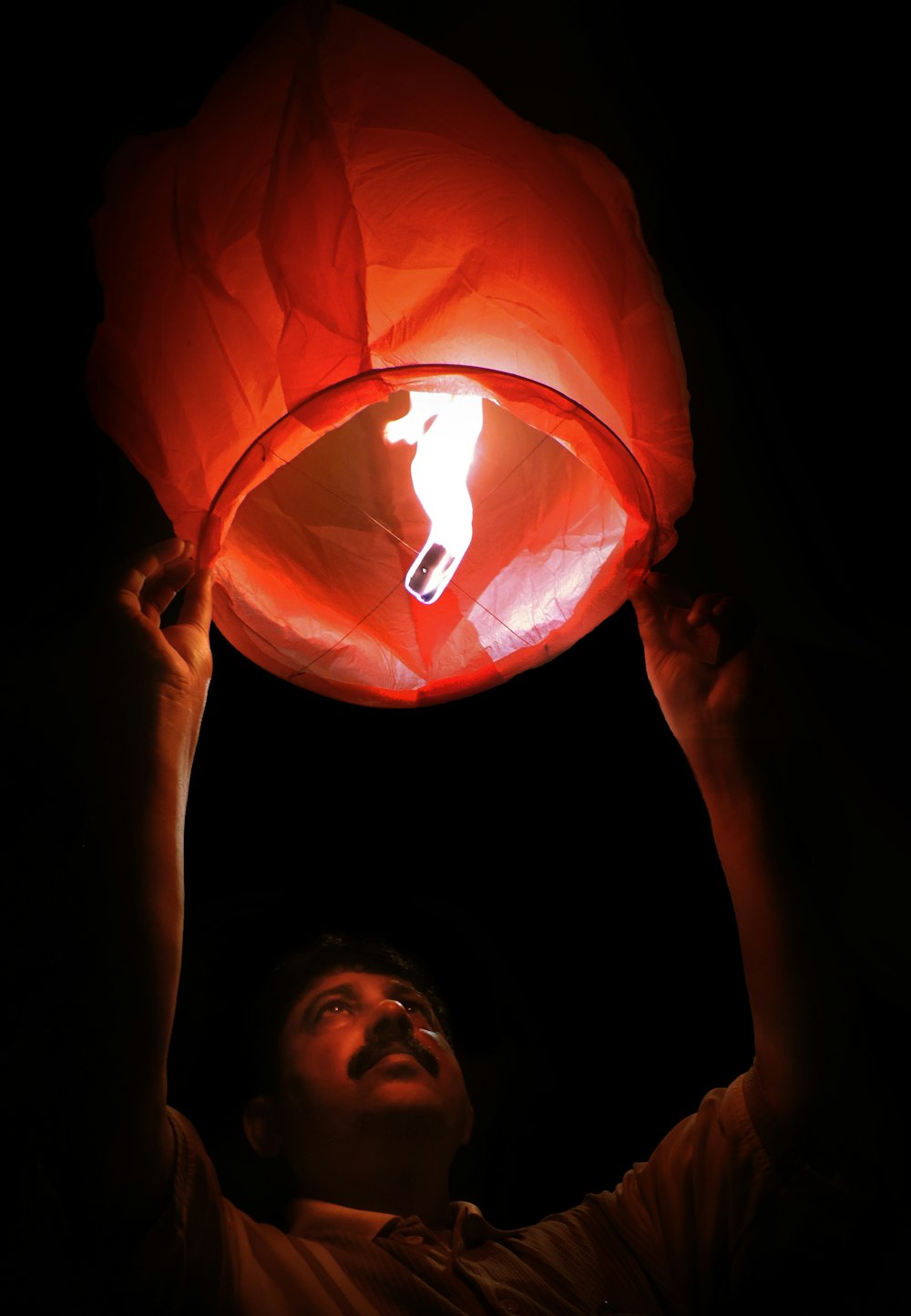 woman holding orange paper lantern