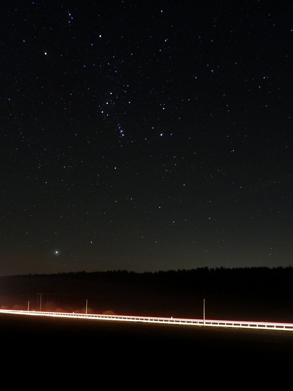 brown wooden fence under starry night