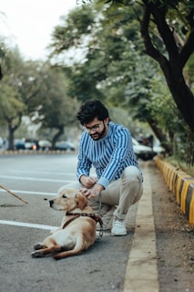man with pet dog on street