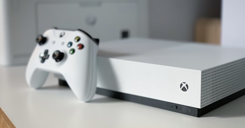 white xbox one console on white table