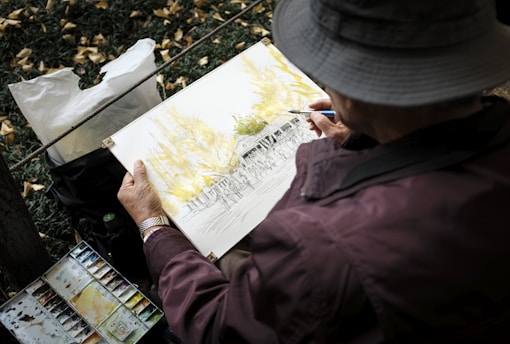 man in red jacket and gray cap holding white printer paper