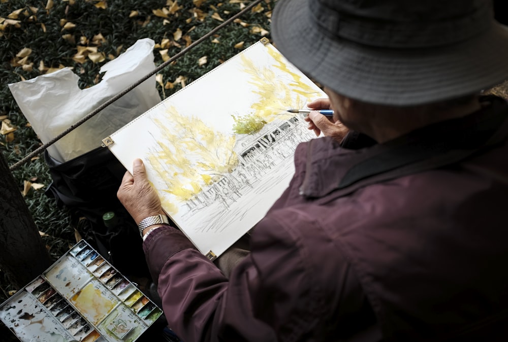 man in red jacket and gray cap holding white printer paper