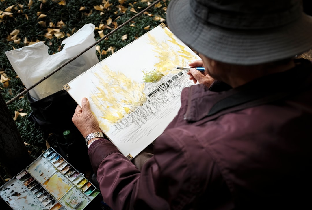 man in red jacket and gray cap holding white printer paper