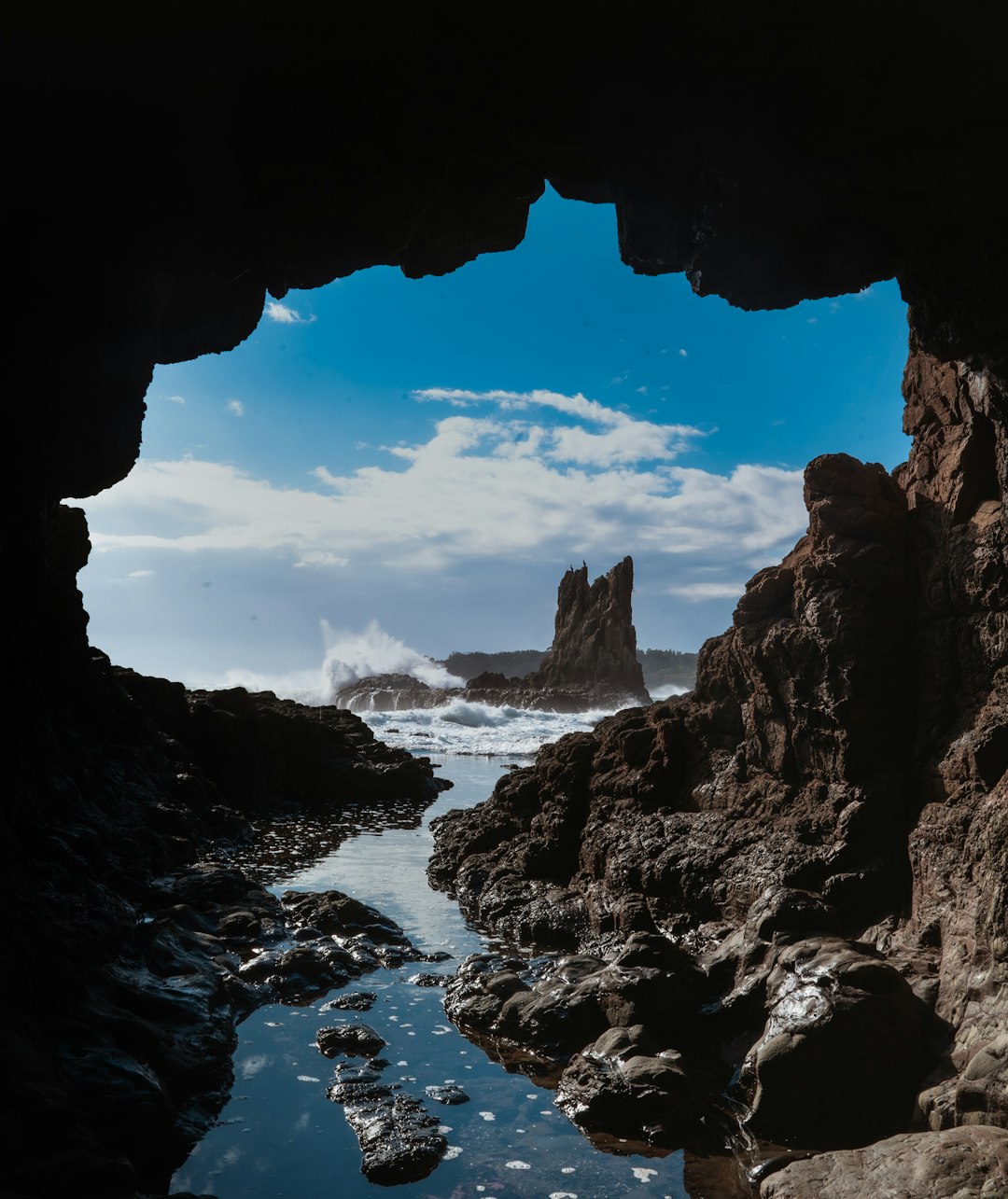 brown rock formation near body of water during daytime