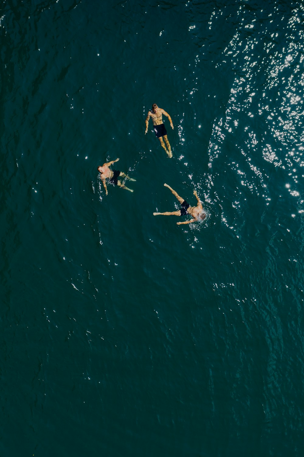 people surfing on blue sea during daytime