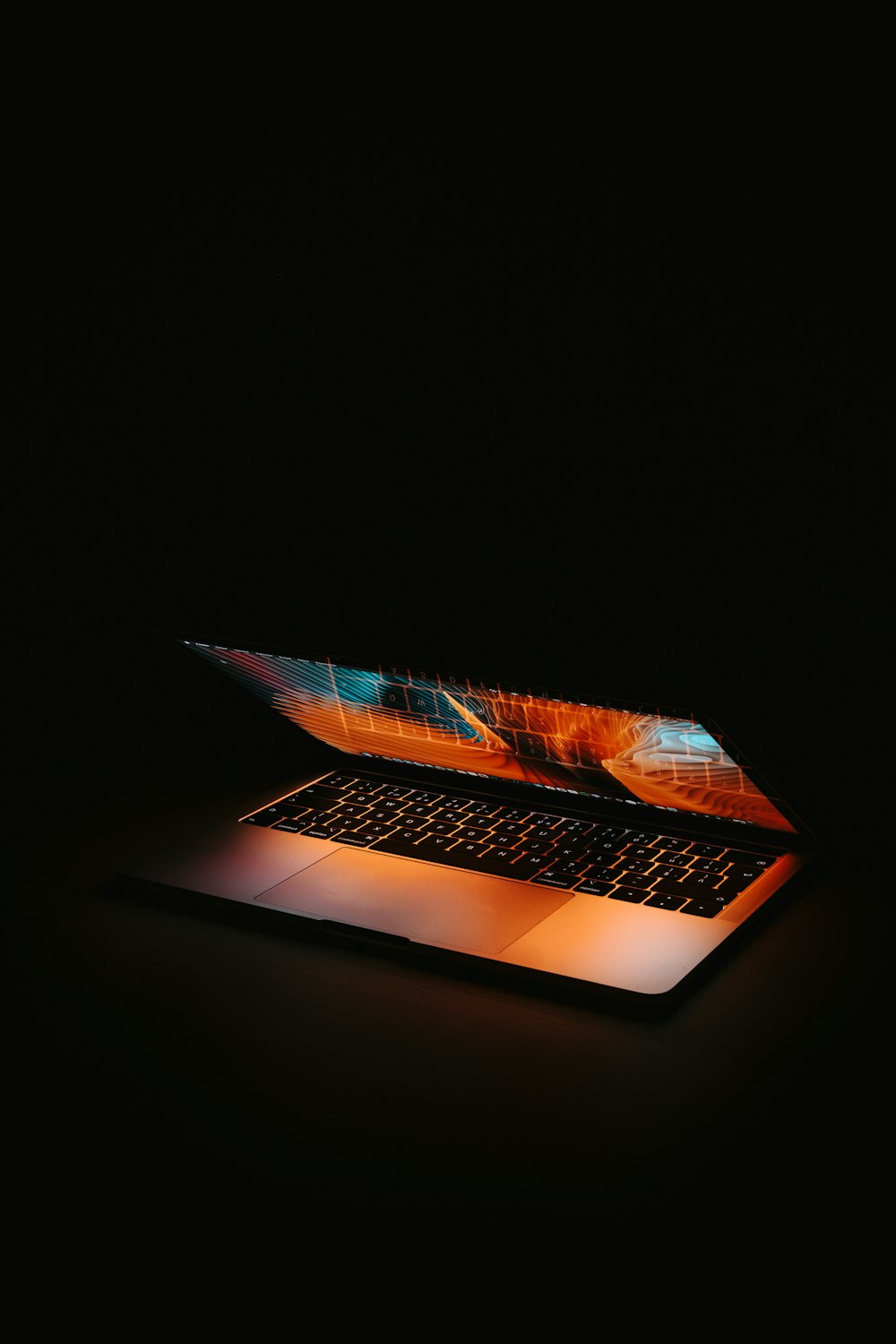 macbook pro on black table