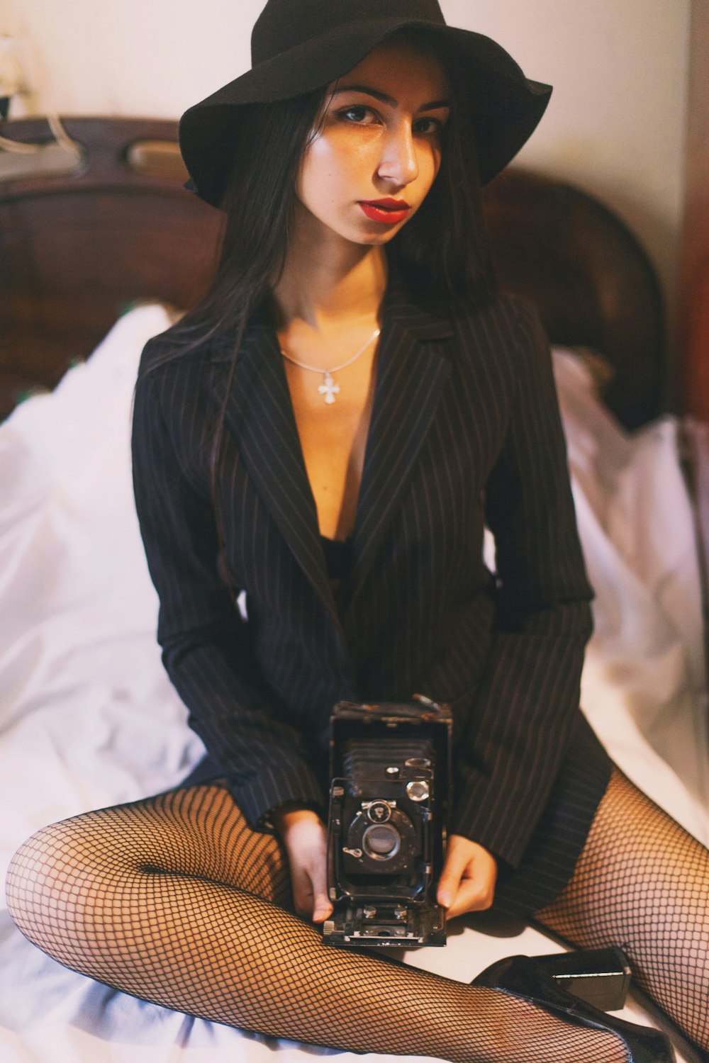 woman in black blazer holding black camera