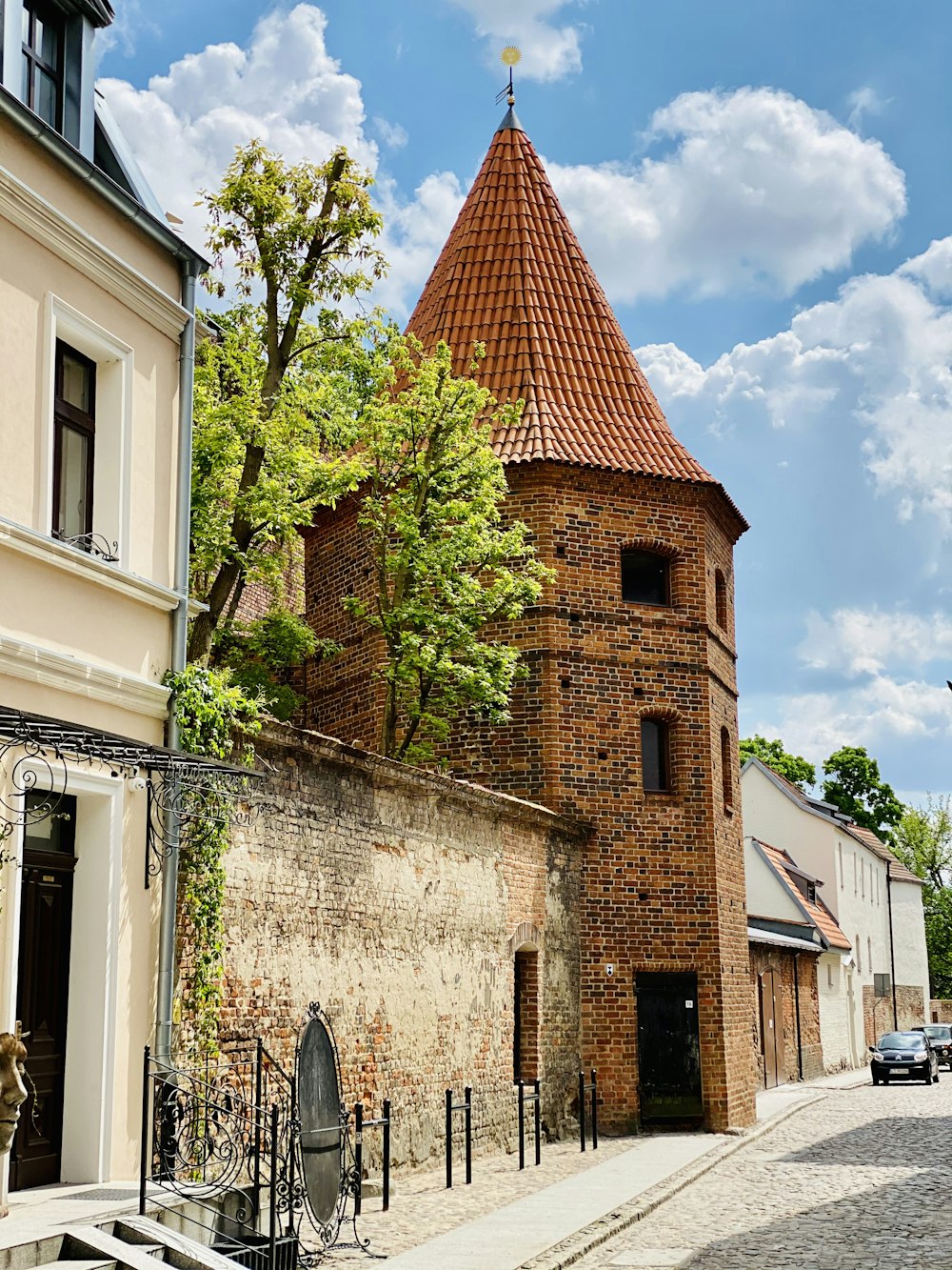 brown brick building near green trees during daytime