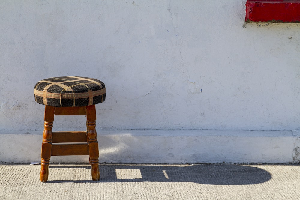 brown wooden round table on gray concrete floor