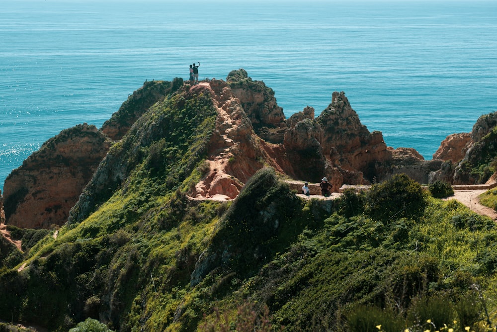 person standing on cliff during daytime