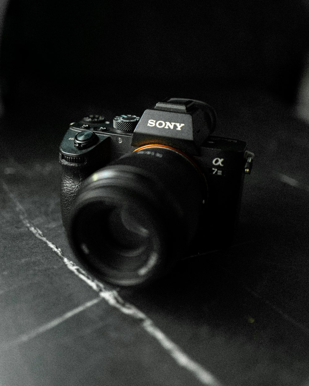 black nikon dslr camera on black wooden table