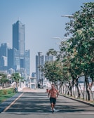 A man jogging in the city wearing lifefitpro activewear, blending urban life and fitness.