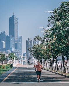 Action shot of a man jogging in Sekille apparel along a park trail in Yogyakarta.