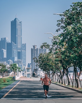 Action shot of a man jogging in Sekille apparel along a park trail in Yogyakarta.