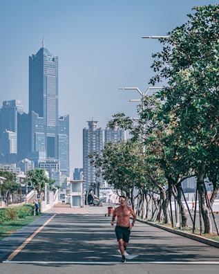 A man jogging in the city wearing lifefitpro activewear, blending urban life and fitness.