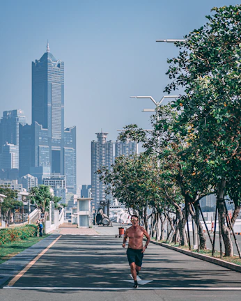 A young man jogging in sleek strideforge athletic wear on a city street at dawn