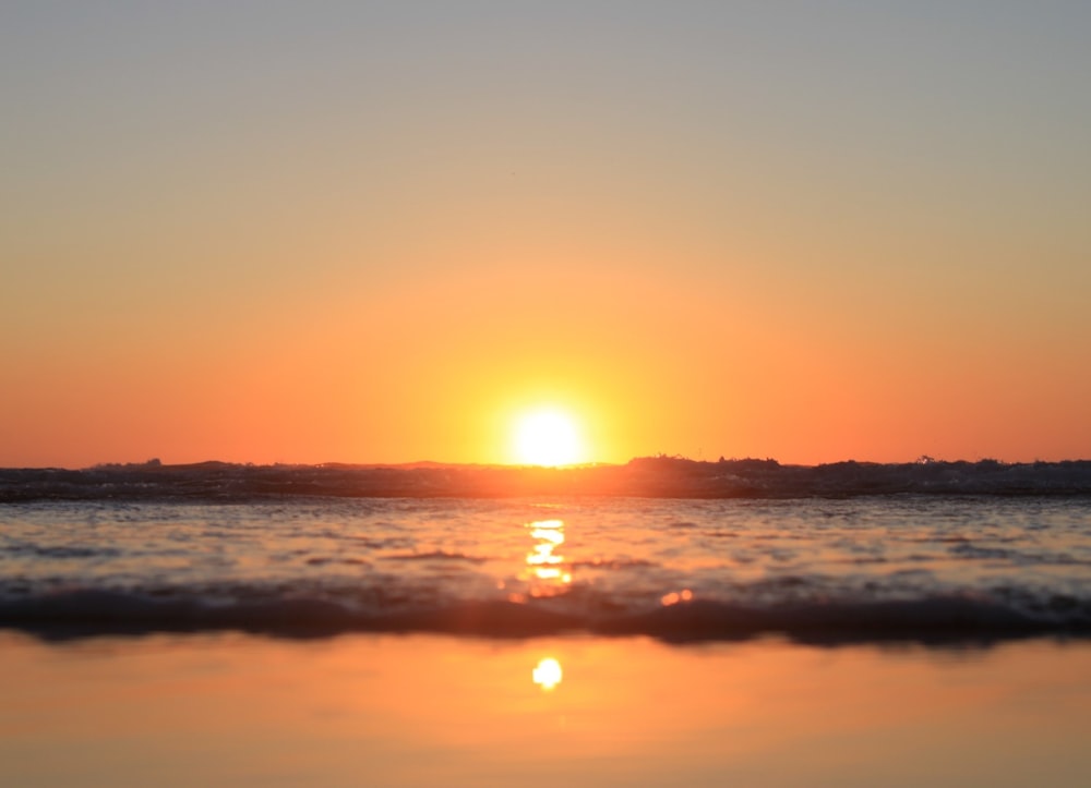 body of water during sunset