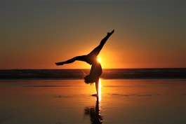 woman in white dress standing on beach during sunset