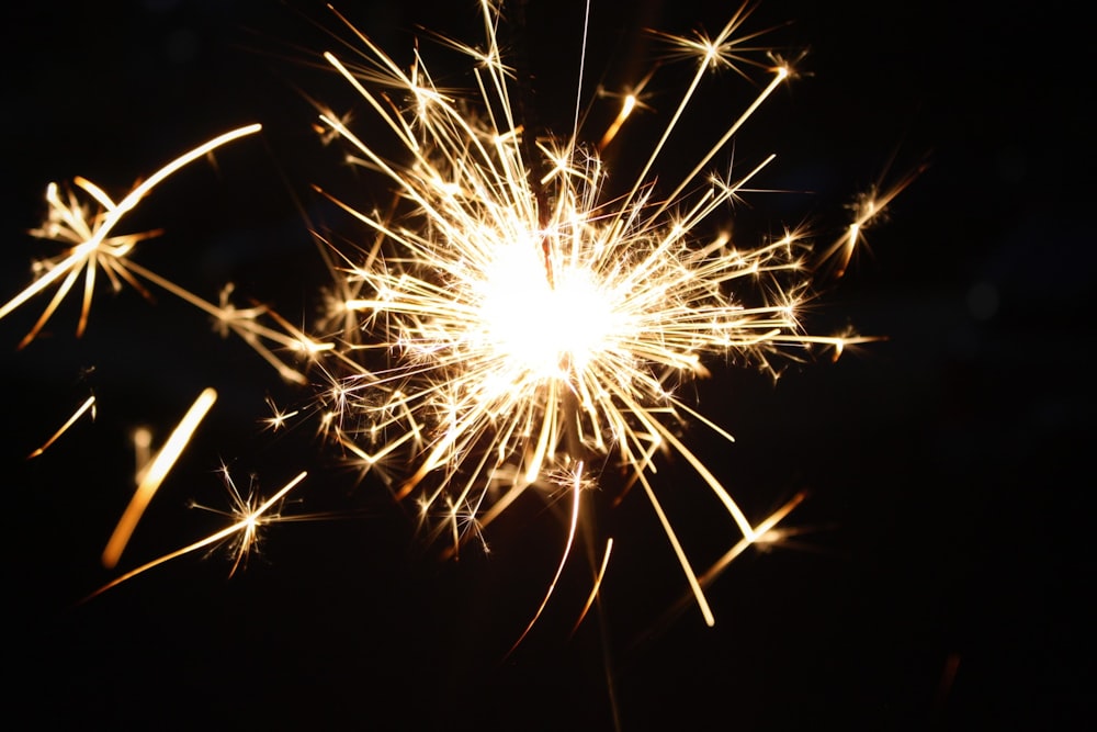 white and yellow fireworks in dark night sky