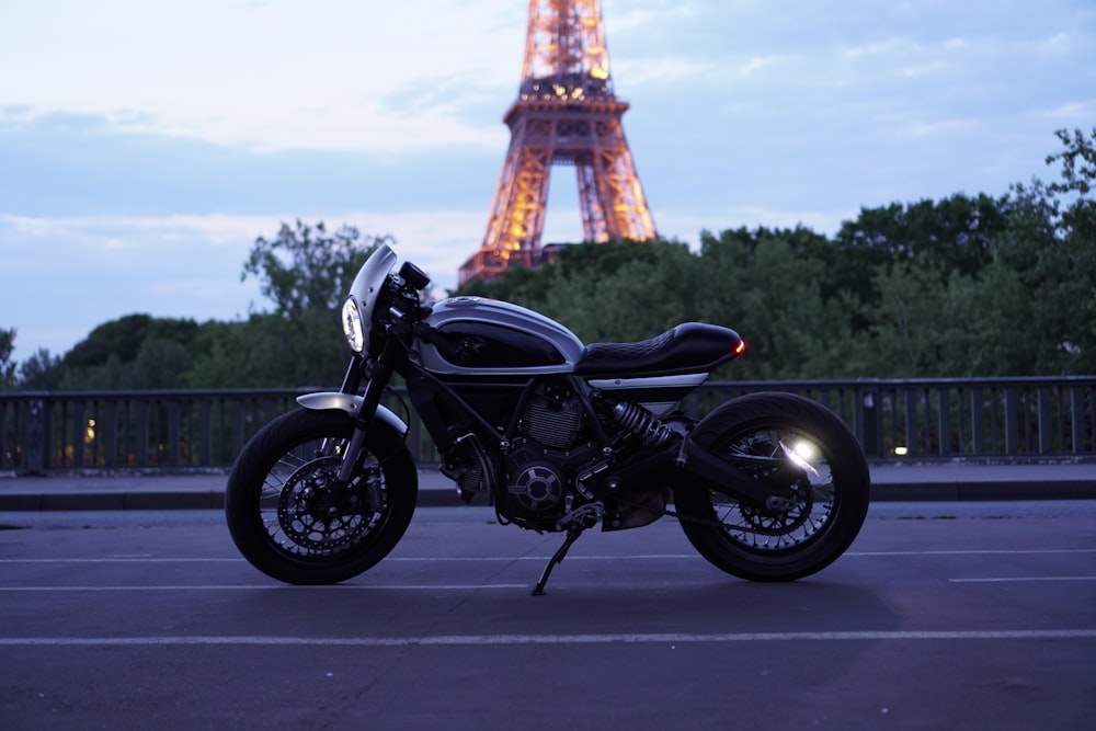 black cruiser motorcycle parked on gray pavement during daytime