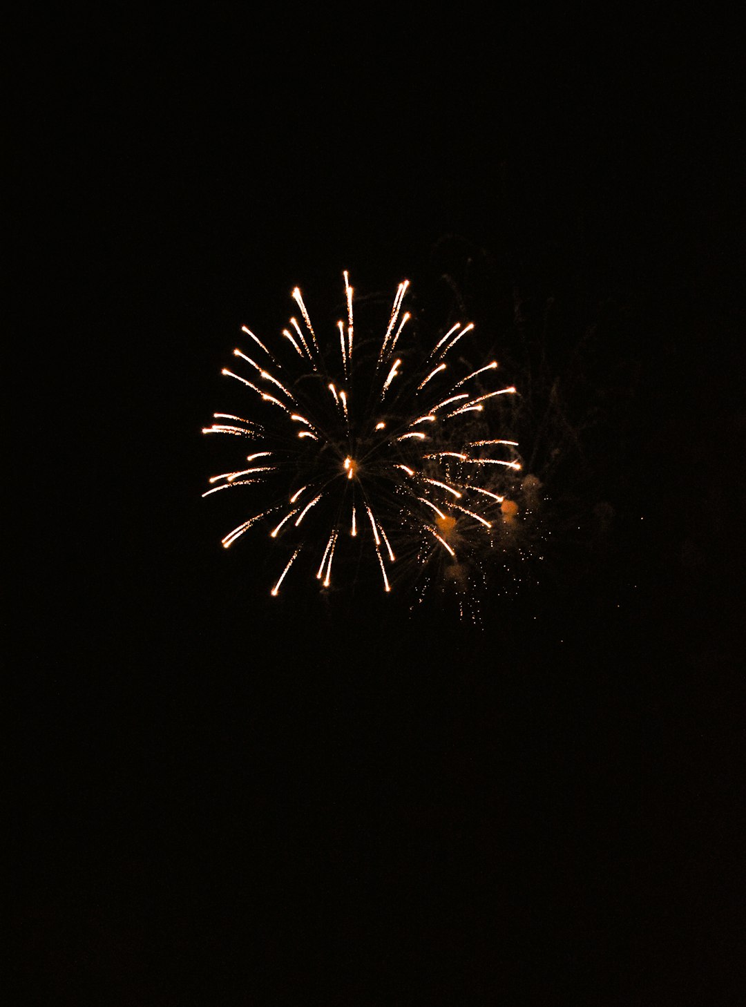 white and yellow fireworks in the sky during nighttime