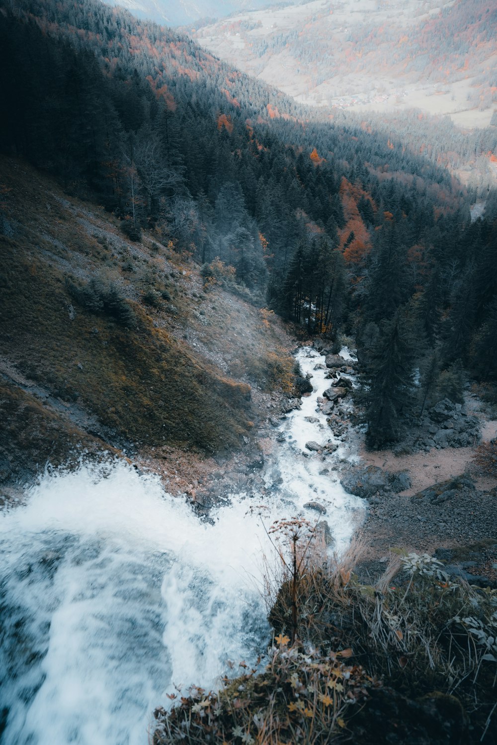 water falls on brown rocky mountain during daytime