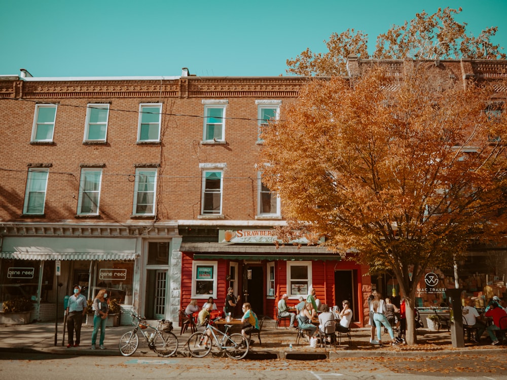 people sitting on bench near brown concrete building during daytime