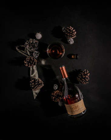 Sophisticated tasting setup with cachaça decana bottle, glass, and gold accents