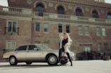 A dynamic shot of an influencer posing with a classic car.