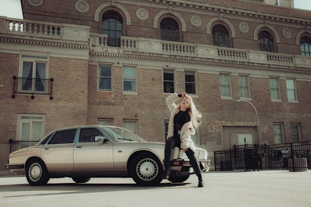 A model striking a confident pose with her pet in a stylish urban setting.