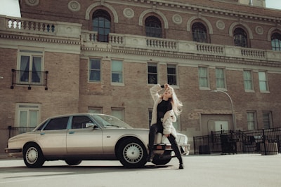 A sleek city street scene featuring a model wearing a sharp, modern outfit from Carlos David Moda.