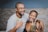 man in white crew neck shirt beside woman in black and brown leopard print bikini top