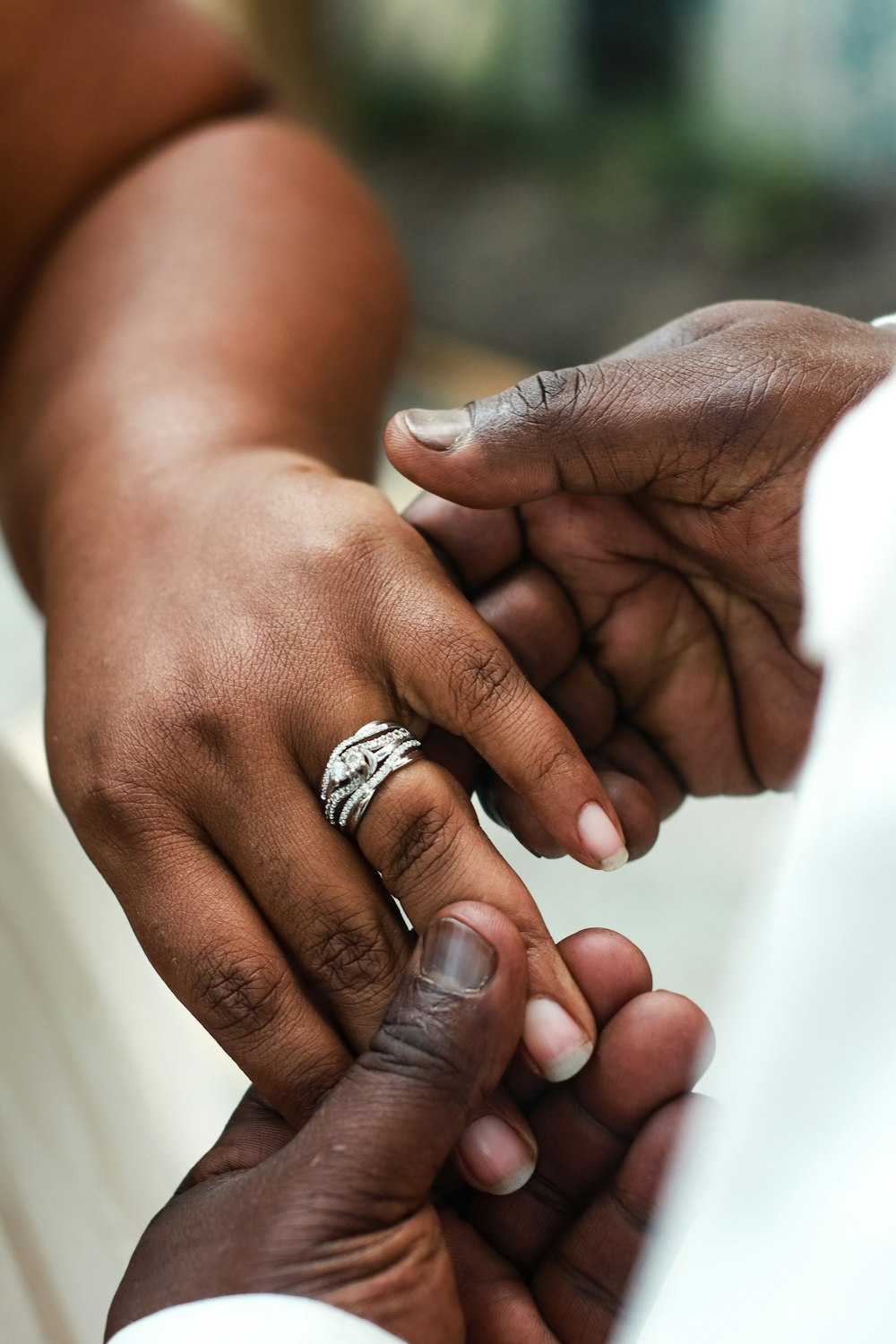 person wearing silver diamond ring